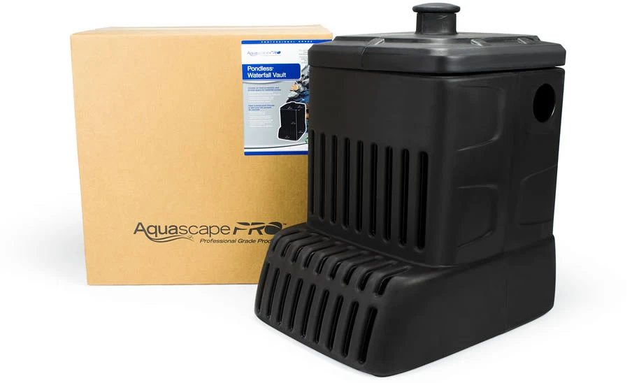 A black pond waterfall vault is positioned next to its brown packaging box labeled AquascapePRO. A product information sheet is attached to the box. A black pond waterfall vault is positioned next to its brown packaging box labeled AquascapePRO. A product information sheet is attached to the box.